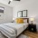 Cozy second bedroom with a comfortable bed, modern furnishings, and soft lighting