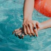 a woman's hand in a pool